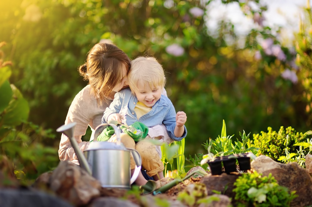 A mom and child gardening
